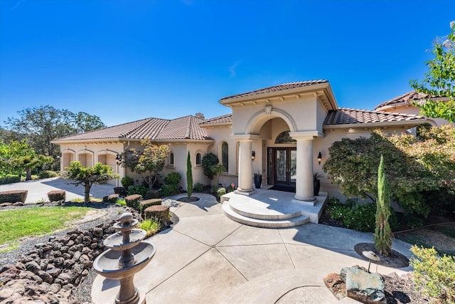 mediterranean / spanish-style house featuring french doors