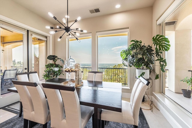 dining room featuring light tile patterned flooring and an inviting chandelier