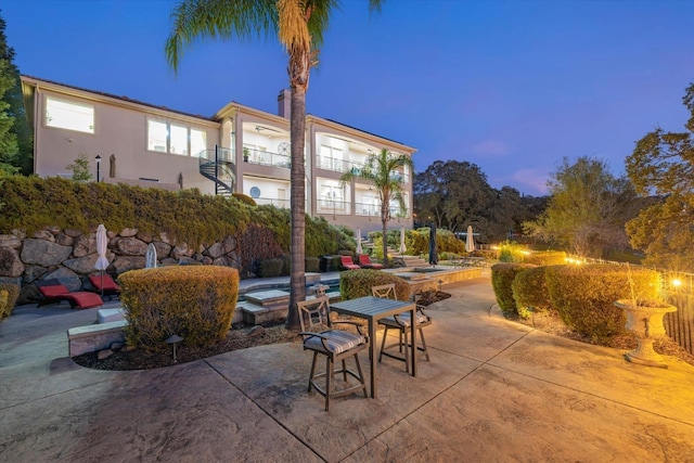 patio terrace at dusk with a balcony