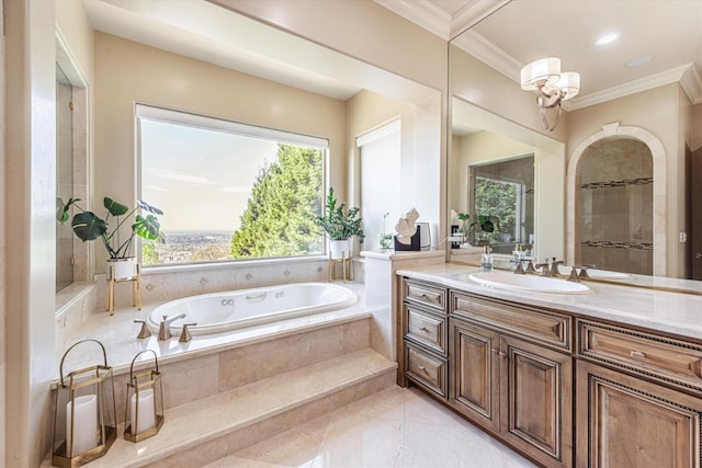 bathroom with tiled bath, vanity, and tile patterned floors