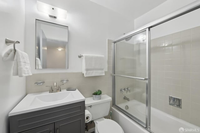 134 Albatross Ct, San Francisco, CA 94124 - bathroom featuring bath / shower combo with glass door, tile walls, vanity, and toilet