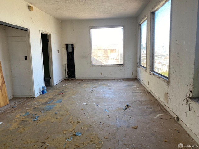 empty room featuring a textured ceiling