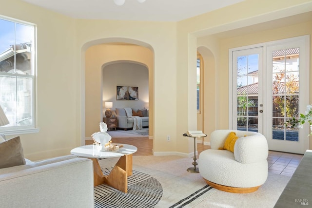 living area featuring light colored carpet and french doors