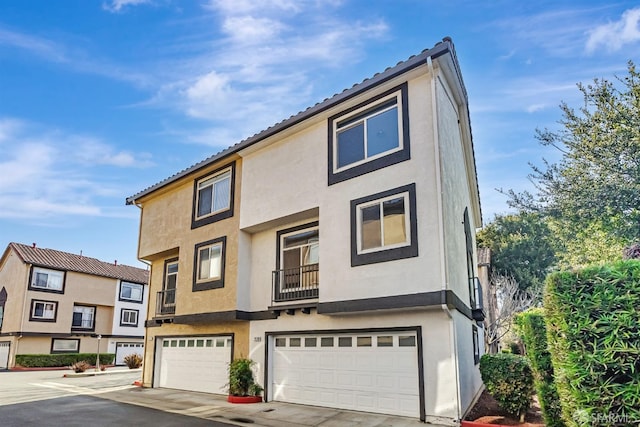 view of property with stucco siding and a garage