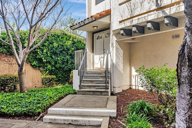 entrance to property featuring stucco siding