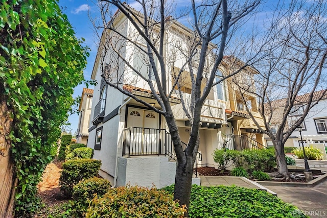 view of front of house featuring a tiled roof and stucco siding