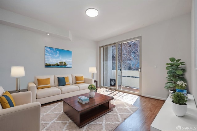living room featuring baseboards and wood finished floors