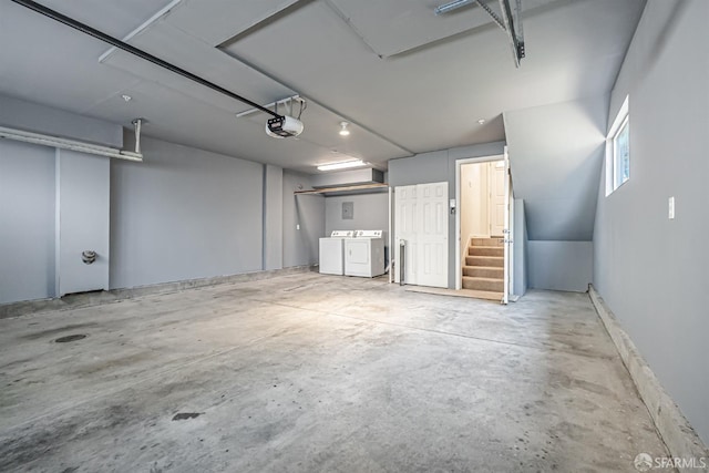 garage featuring a garage door opener and washer and dryer