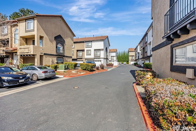 view of road featuring curbs and a residential view