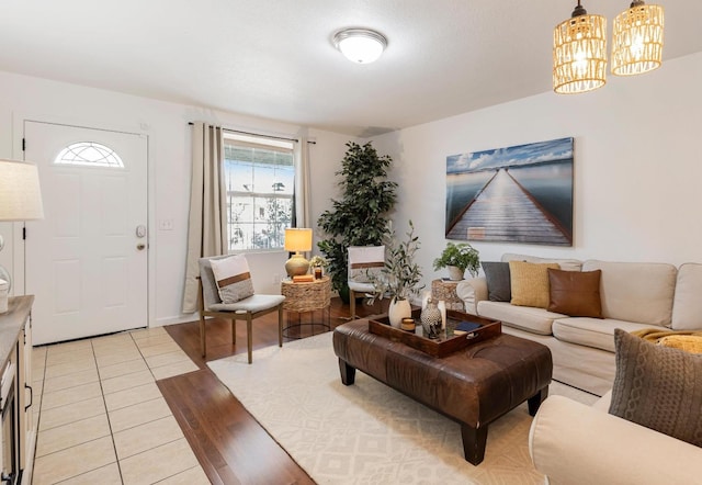 tiled living room featuring an inviting chandelier