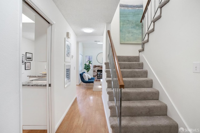 3937 Vine St, Pleasanton, CA 94566 - stairway featuring wood finished floors, a fireplace, and baseboards