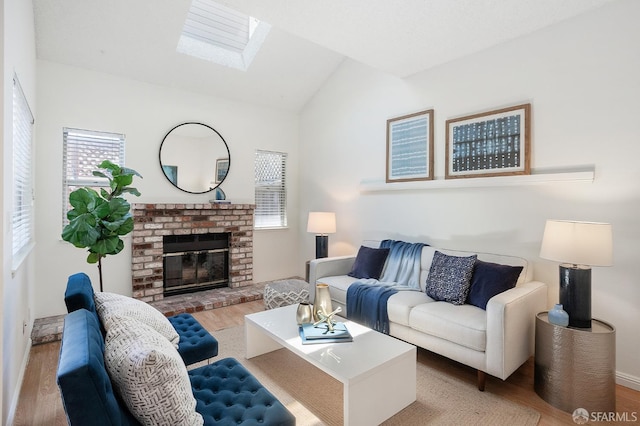 3937 Vine St, Pleasanton, CA 94566 - living area with wood finished floors, a skylight, vaulted ceiling, a brick fireplace, and baseboards