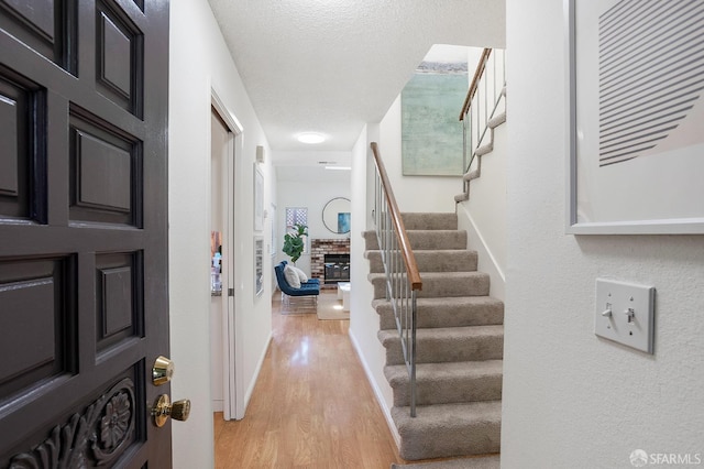 3937 Vine St, Pleasanton, CA 94566 - foyer entrance featuring light wood finished floors, stairway, and a fireplace