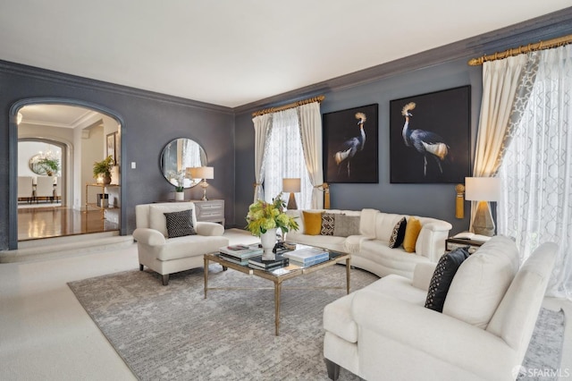 living room featuring arched walkways and crown molding