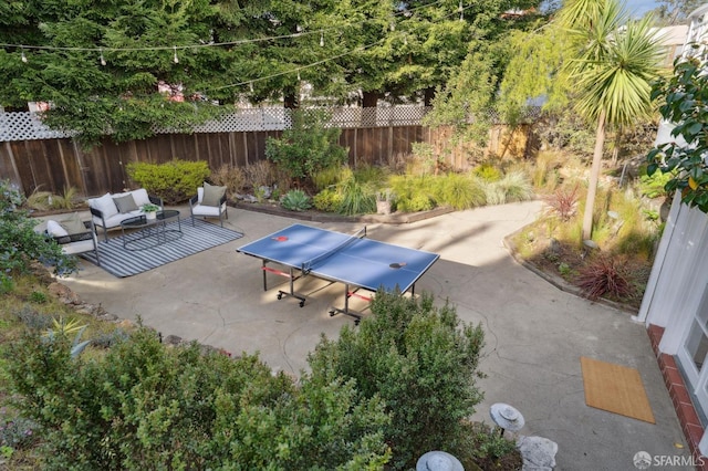 view of patio featuring fence and an outdoor hangout area