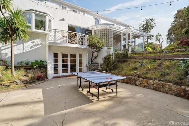 view of patio with french doors and a balcony