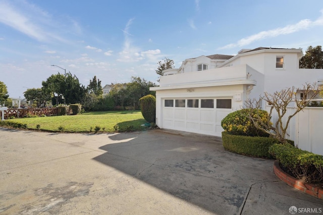 garage featuring concrete driveway