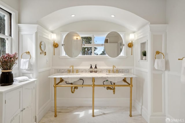 bathroom featuring marble finish floor and a sink