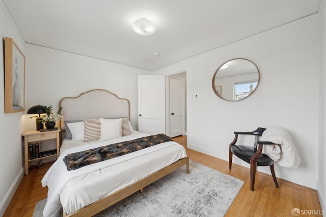 bedroom with wood finished floors and baseboards