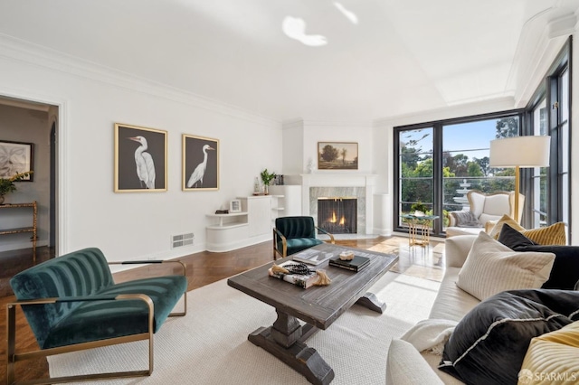 living room with ornamental molding, a fireplace, and baseboards