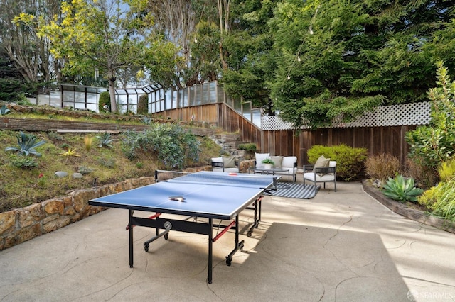 view of patio / terrace featuring stairs, fence, and outdoor dining area