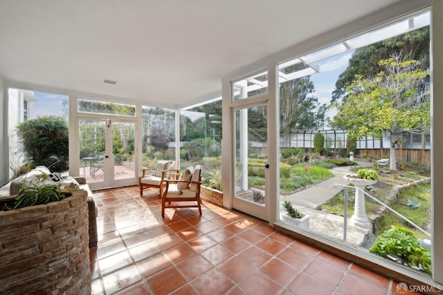 sunroom / solarium featuring plenty of natural light and french doors