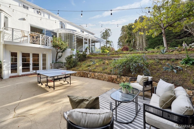 view of patio with a balcony and an outdoor living space