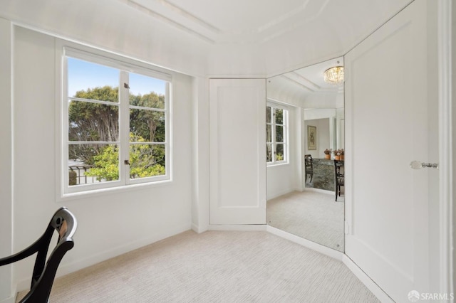 interior space with a chandelier and carpet flooring