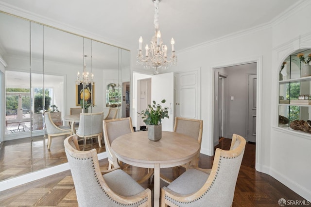 dining space featuring an inviting chandelier, baseboards, and crown molding