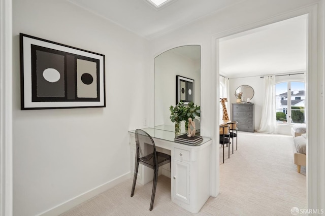 office featuring baseboards and light colored carpet