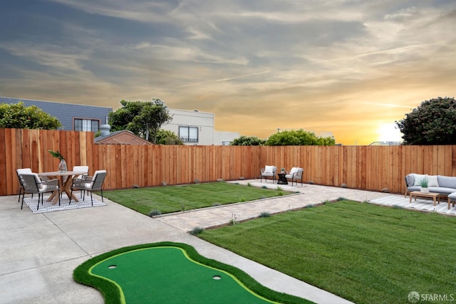2277 33rd Ave, San Francisco, CA 94116 - yard at dusk with a putting area, a patio, a fenced backyard, and outdoor lounge area