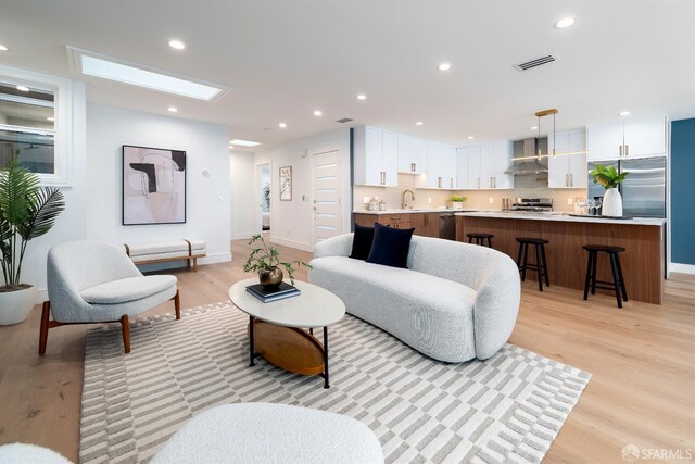 2277 33rd Ave, San Francisco, CA 94116 - living area featuring light wood-type flooring and recessed lighting
