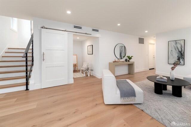 2277 33rd Ave, San Francisco, CA 94116 - living room with a barn door, stairs, light wood-style flooring, and recessed lighting