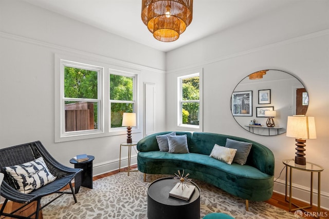 living area with baseboards and wood finished floors