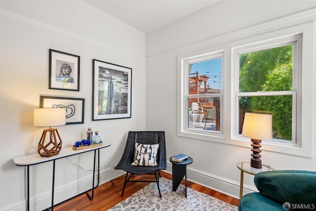 sitting room with wood finished floors and baseboards
