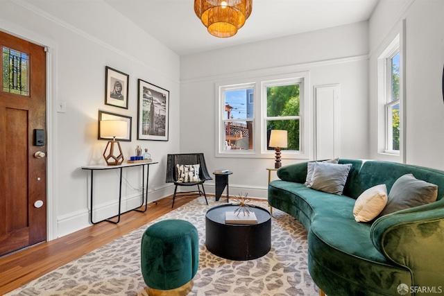 living area with healthy amount of natural light, wood finished floors, and baseboards