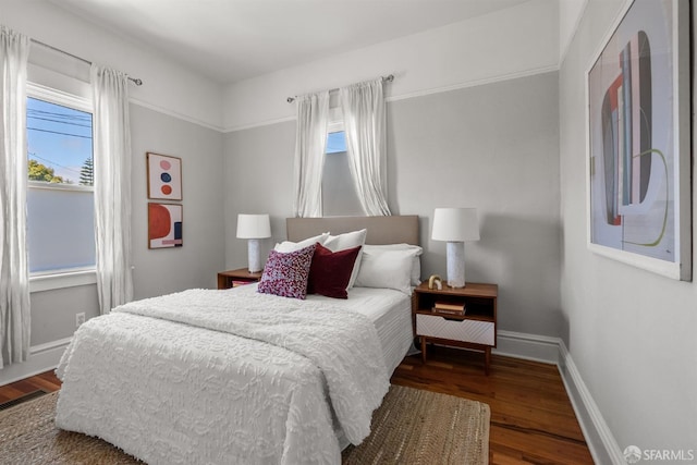 bedroom with wood finished floors and baseboards
