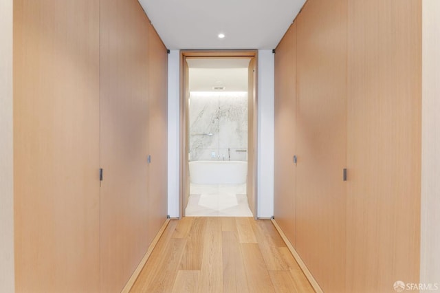 hall with hardwood / wood-style floors