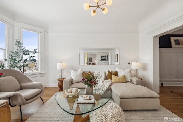 living area featuring a chandelier and wood finished floors