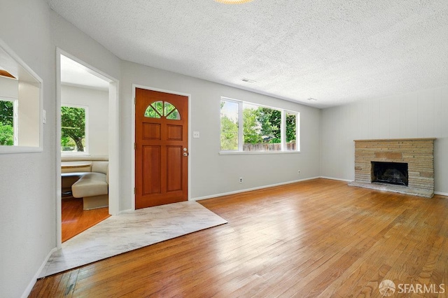 1835 Clayton Way, Concord, CA 94519 - foyer featuring wood-type flooring, healthy amount of natural light, a textured ceiling, and a stone fireplace