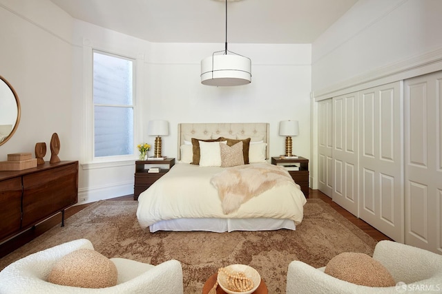 bedroom featuring hardwood / wood-style floors and a closet