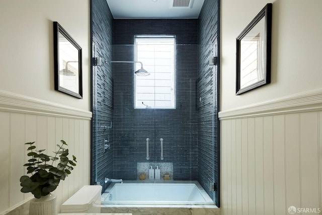 bathroom with tiled shower / bath combo and a wealth of natural light