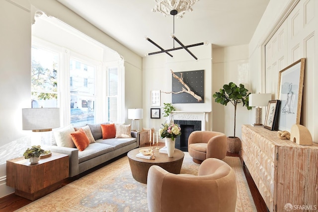 living room with a high end fireplace and an inviting chandelier