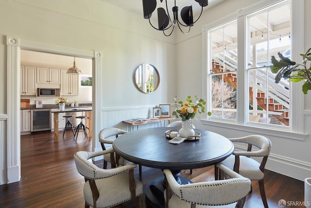 dining space with dark wood-type flooring and wine cooler