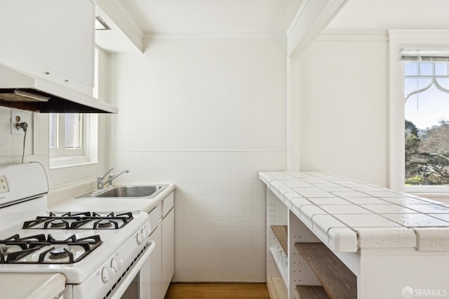 516 Stanyan St, San Francisco, CA 94117 - kitchen with white range with gas cooktop, ornamental molding, tile counters, tile walls, and a sink