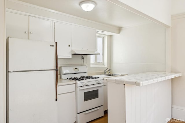 516 Stanyan St, San Francisco, CA 94117 - kitchen featuring white appliances, white cabinetry, under cabinet range hood, a sink, and tile counters