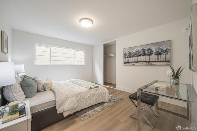 bedroom with hardwood / wood-style flooring and a closet