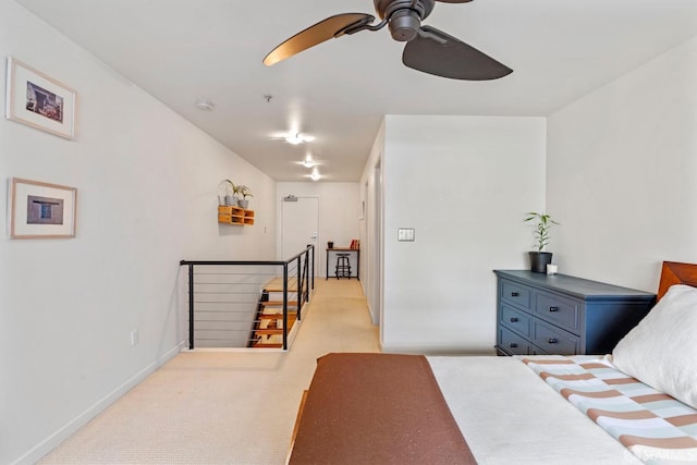 bedroom with a ceiling fan and baseboards