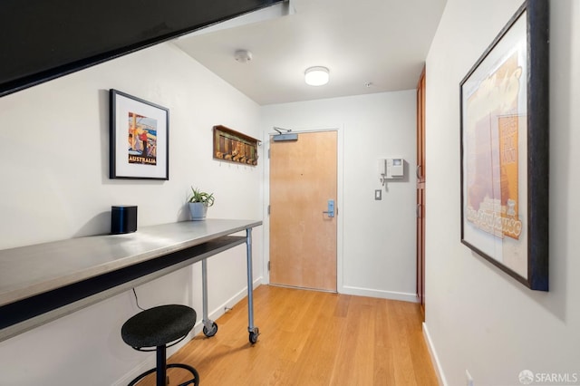 entrance foyer featuring light wood-type flooring and baseboards