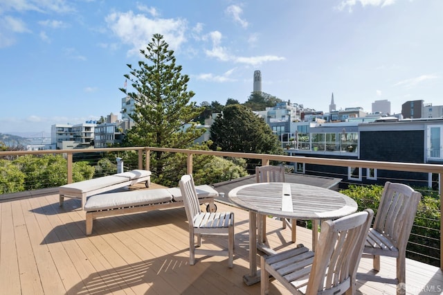 wooden deck with a view of city